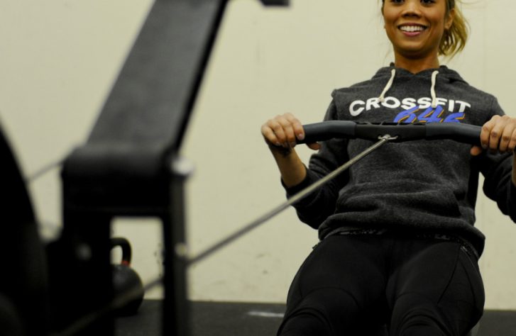 Air Force U.S. Staff Sgt. Camille Galang, 355th Fighter Wing Command Post emergency action controller, exercises with a rowing machine at Davis-Monthan Air Force Base, Jan. 29, 2016. Galang felt the CrossFit program needed attention because they were having difficulties retaining coaches. She presented her idea to resolve the issue during the innovate DLT event. (U.S. Air Force photo by Airman Basic Nathan H. Barbour/Released)